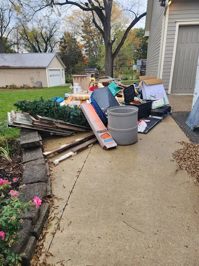 Dumpster being loaded with debris for Roofing Dumpster Rental in Washington Court House